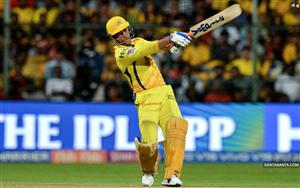 Indian cricketer Mahendra Singh Dhoni posing with the bat